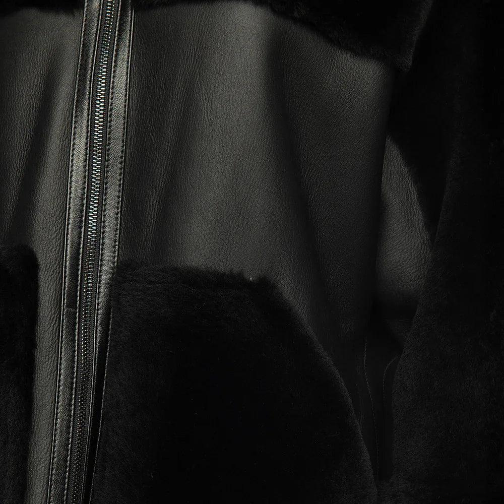 Close-up of a black leather jacket with a zipper