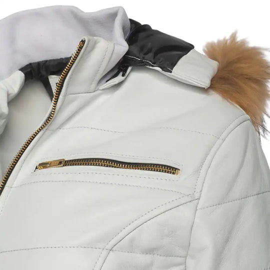 Detailed view of the jacket’s front closure, showing how the gold-toned zipper complements the metallic white leather exterior.