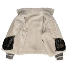 Interior shot of Aiden's Grey Trucker Jacket, highlighting the plush white shearling lining. The jacket is open, displaying the soft, warm fur lining throughout the inner surface, with black leather accents on the elbows.