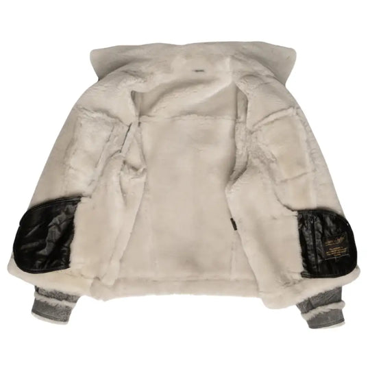 Interior shot of Aiden's Grey Trucker Jacket, highlighting the plush white shearling lining. The jacket is open, displaying the soft, warm fur lining throughout the inner surface, with black leather accents on the elbows.
