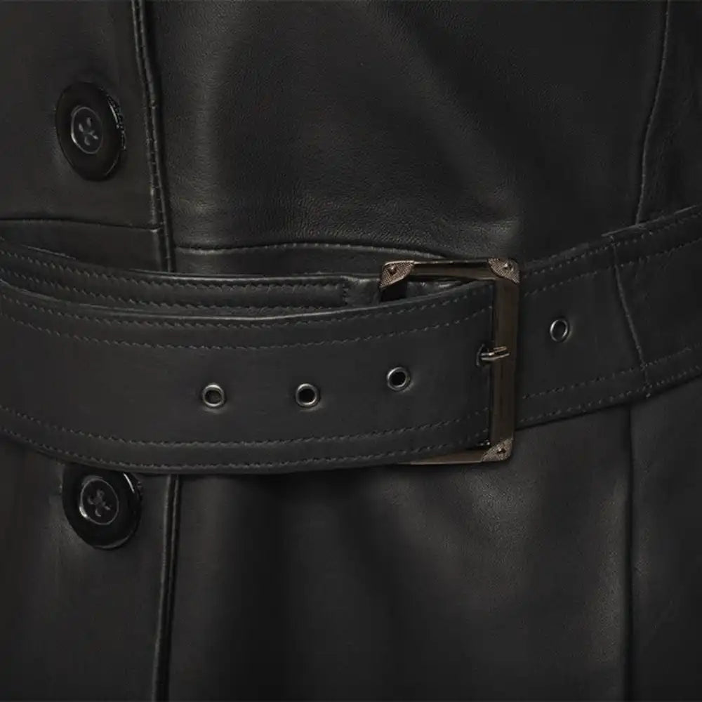 Close-up of a black leather jacket with a belt and buttons.