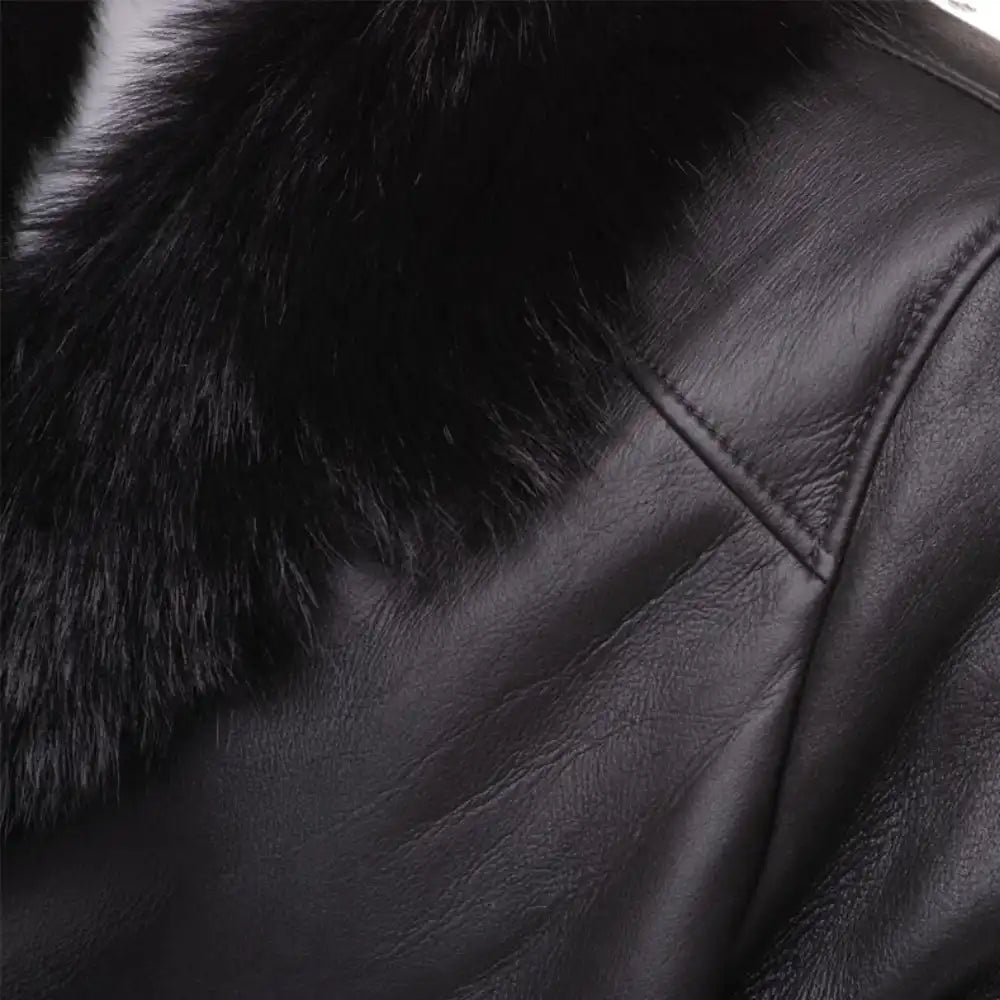 Close-up of a black shearling trench coat with fur collar.
