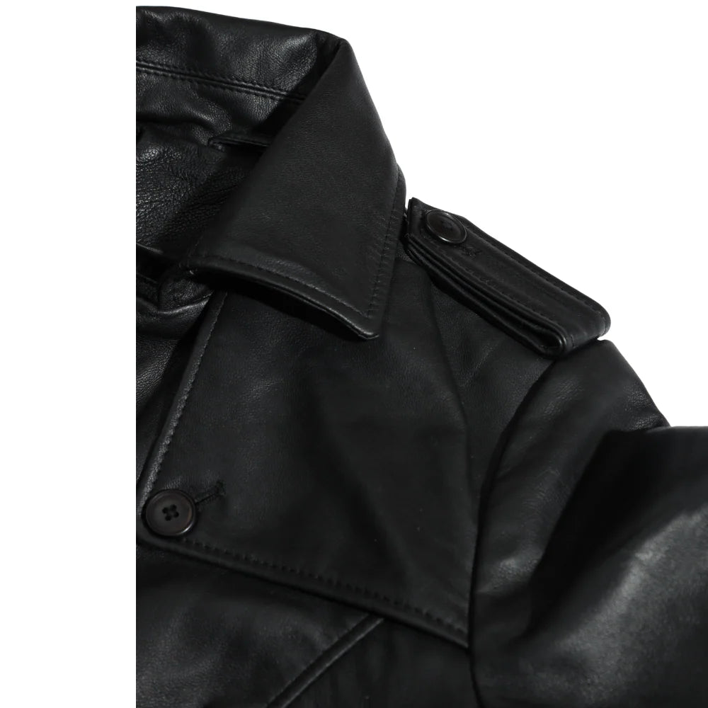 Close-up of a black leather coat with a button on a white background