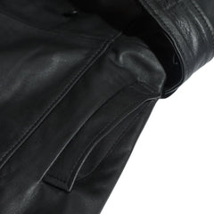 Close-up of a pocket of a black leather coat on a white background.