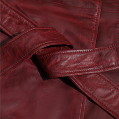Close-up of a red leather jacket belt with visible stitching