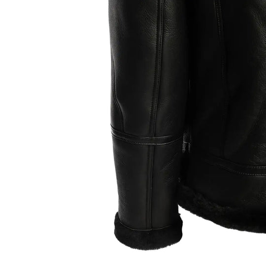 Detailed view of the sleek black bomber shearling jacket’s ribbed knit cuffs, adding a stylish and snug finish to the jacket's design.