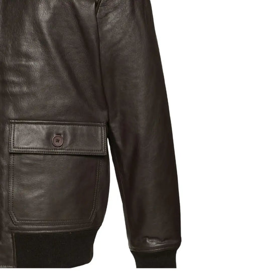 Close-up view of the button-flap pockets on the Havana brown G1 Bomber leather jacket, featuring functional and stylish detailing.
