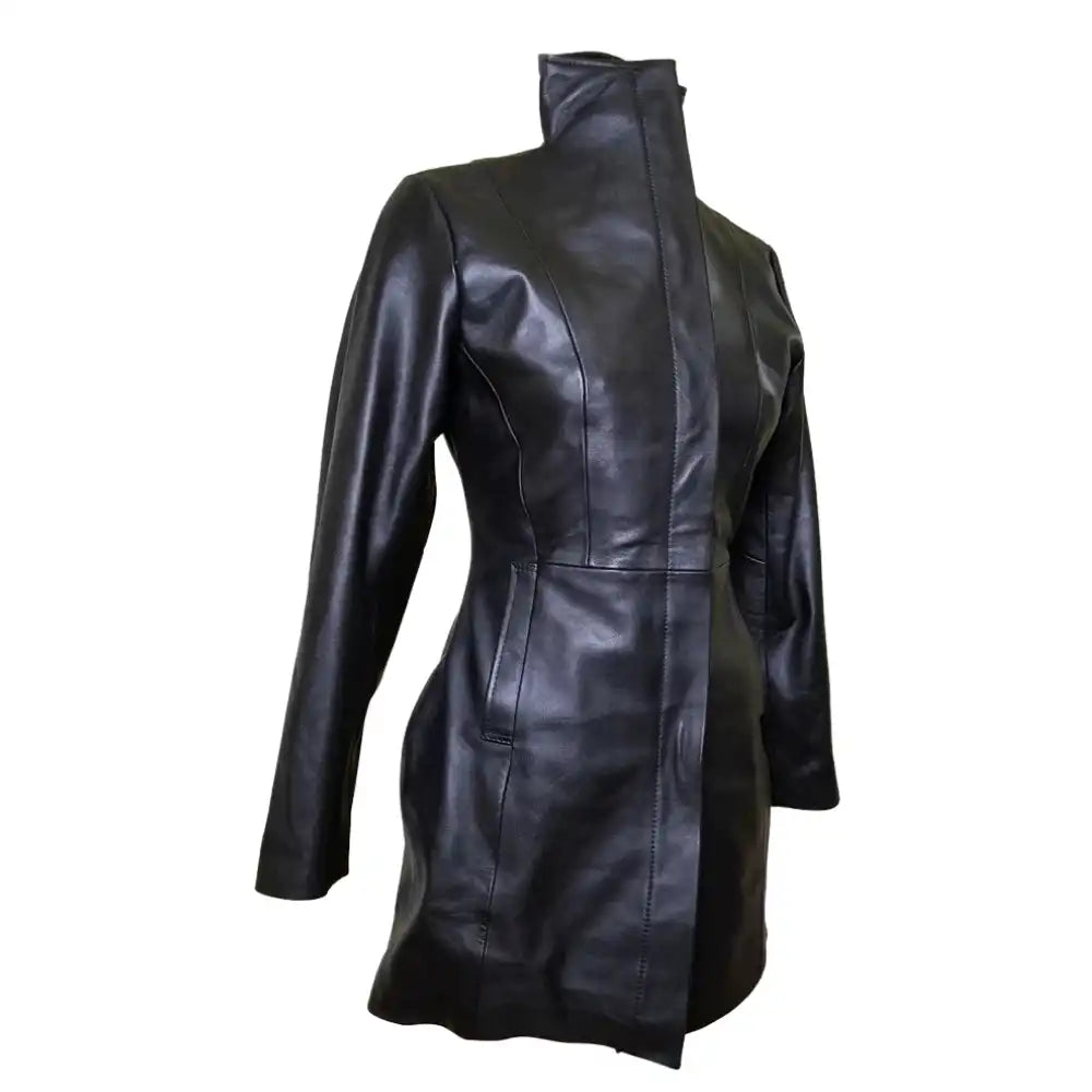 Side profile view of Nelly's women's long leather coat on a mannequin, featuring double wind flaps and pockets and a button-down closure.