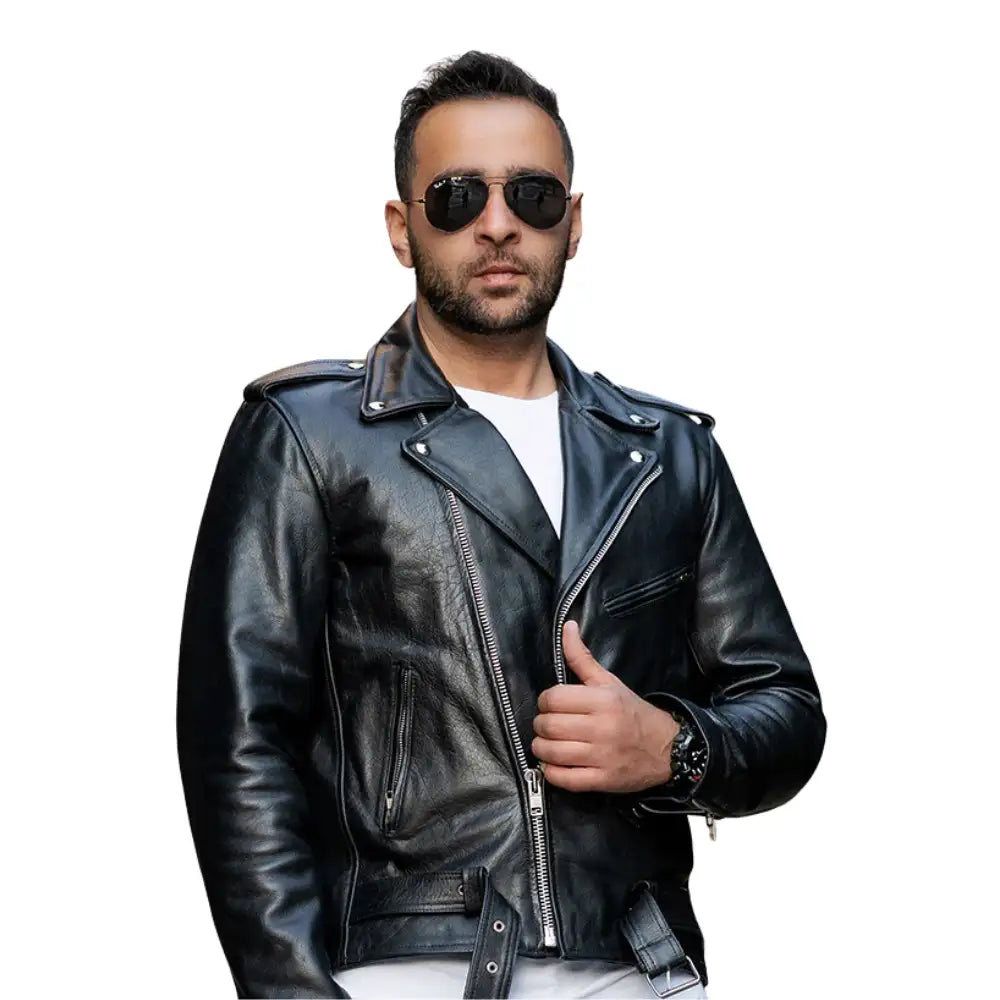 A male model wearing the Perfect Biker Style heavy leather biker jacket, standing in a classic leaning pose that highlights the asymmetrical zipper and belted waist.