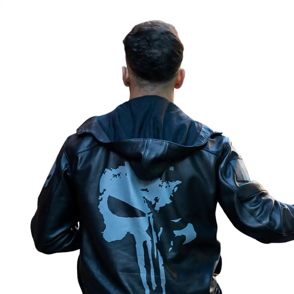 A back side of the male model wearing the Punisher's leather motorcycle jacket while standing next to a cruiser bike, showcasing the jacket's fit and aggressive style.