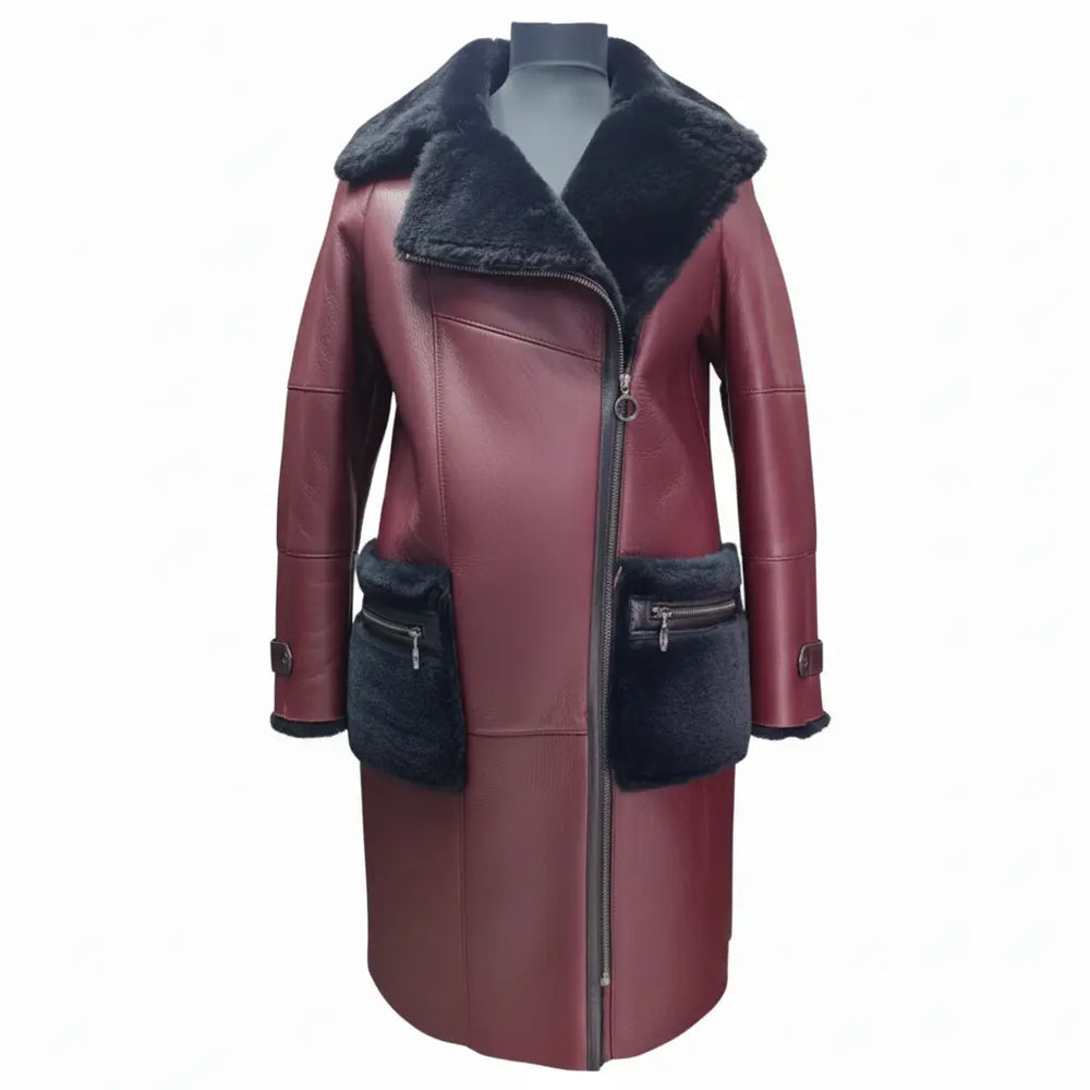 A full-length front view of Samira's burgundy shearling trench coat for women, featuring a large black fur lapel collar, asymmetrical zipper closure, and oversized black fur-trimmed pockets with zippers on white background.