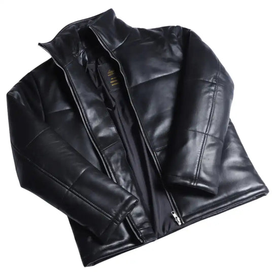 View of the Sorine women’s black leather puffer jacket, featuring a slim-fit quilted design and a high stand-up collar.
