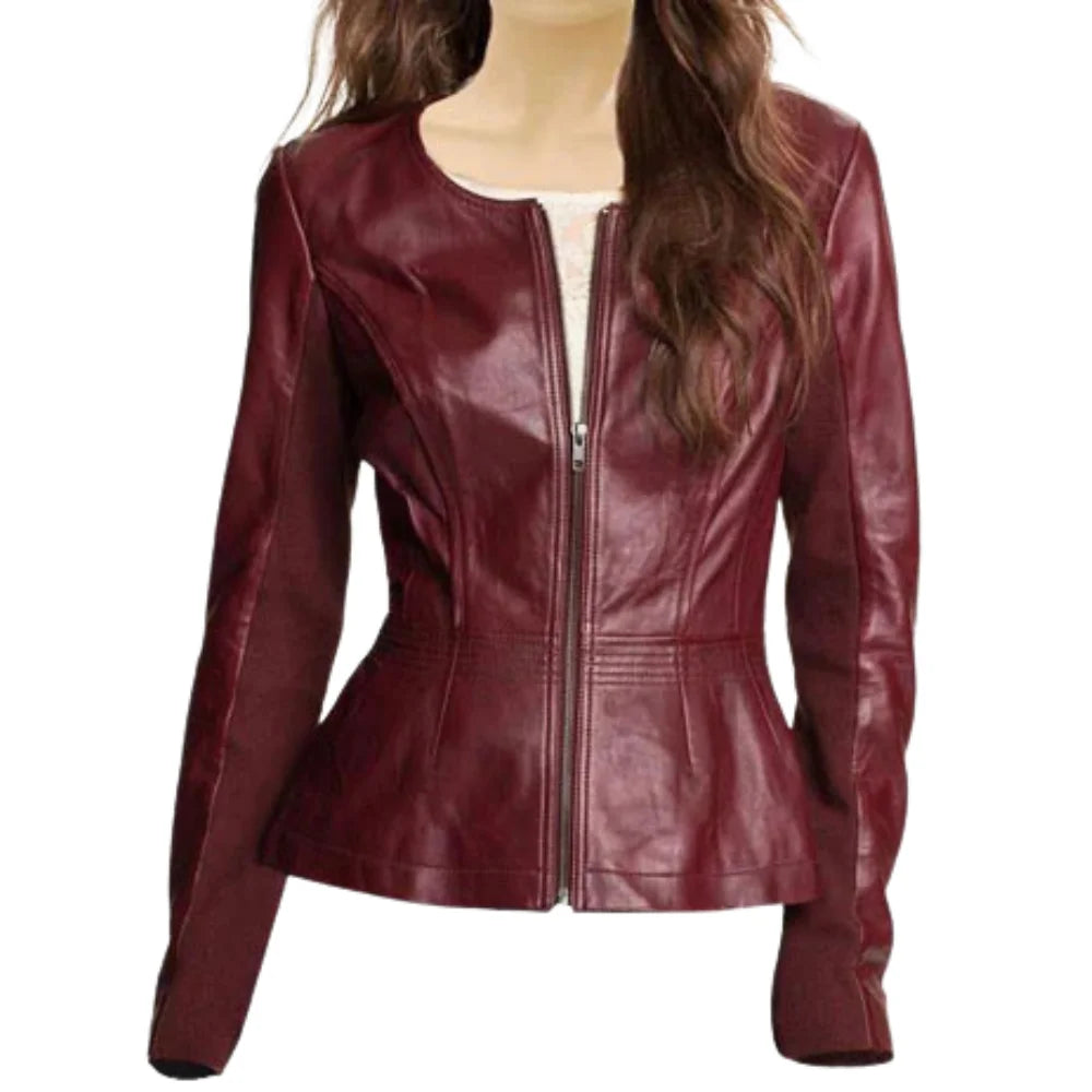 A front view of a women’s maroon collarless leather jacket featuring a sleek round neckline, silver center zipper, and horizontal quilted stitching on the shoulders and arms.